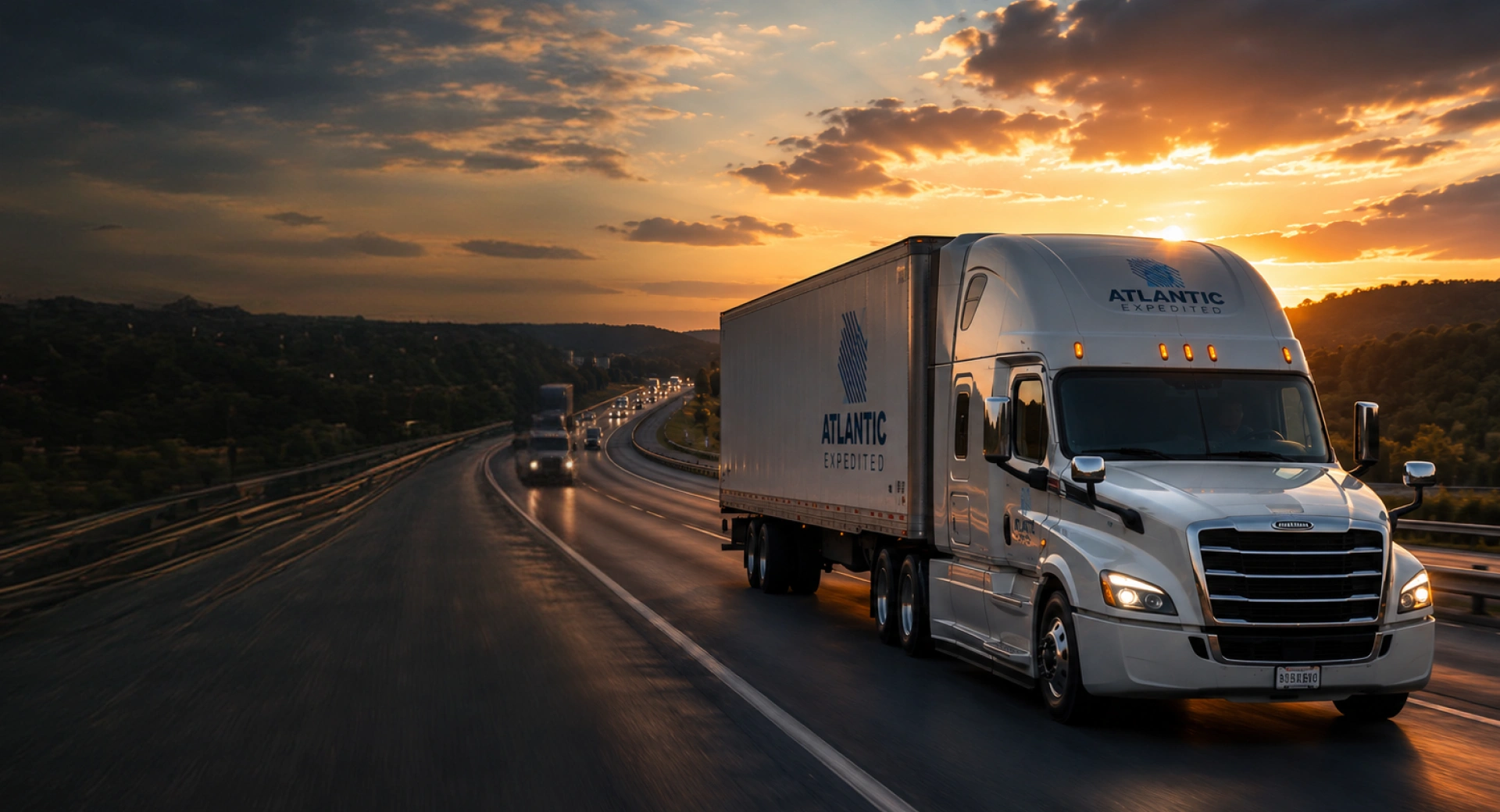 Atlantic Expedited semi truck hauling freight on the highway at sunset
