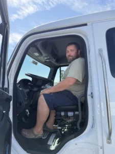 Atlantic Expedited driver Dima in the cab of a Freightliner M2